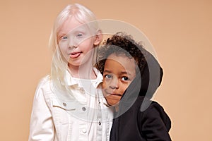 Beautiful albino girl with little multiracial boy isolated