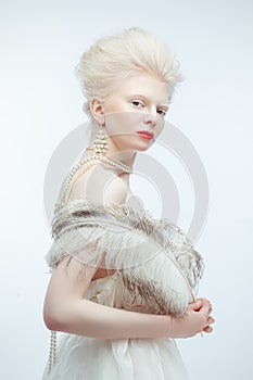 Beautiful albino girl with red lips on white background