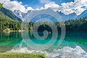 Beautiful alpine lake near Italain border with dramatic sky,Lake Fusine