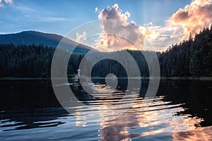 Beautiful alpine lake Synevyr in Carpathian mountains at sunset, colorful landscape