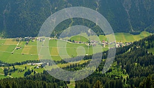 Beautiful alpine landscape with green meadows, alpine cottages and mountain peaks, Lechtal, Lech, Austria