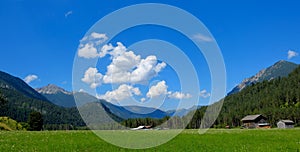 Beautiful alpine landscape with green meadows, alpine cottages and mountain peaks, Lechtal, Lech, Austria