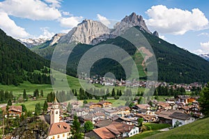 Beautiful alpine landscape. Village Pozza di Fassa at the foot of Dolomites photo