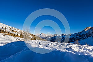 Beautiful alpine panoramic view of snowy mountains, beautiful European winter mountains in Italy Dolomites, lope for cross country