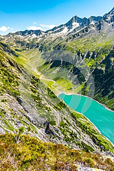 Beautiful alpine walley with azure blue water dam