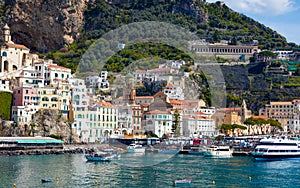 Beautiful Amalfi on hills leading down to coast, azure sea in Campania, Italy photo