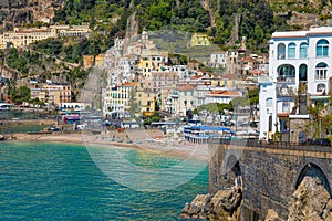 Beautiful Amalfi on hills leading down to coast, comfortable beaches and azure sea in Campania, Italy