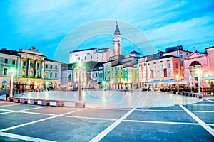 Beautiful amazing city scenery in the central square with the old clock tower in Piran, the tourist center of Slovenia in the