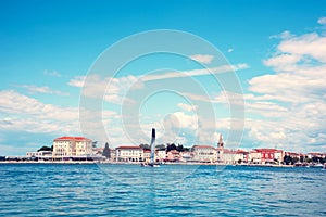 Beautiful amazing city scenery with the old tower in Porec, the tourist center of Croatia from sea. popular tourist attraction.