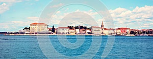 Beautiful amazing city scenery with the old tower in Porec, the tourist center of Croatia from sea. popular tourist attraction.