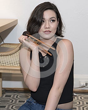 Beautiful Amerasian 19 year old girl with beginner chopsticks