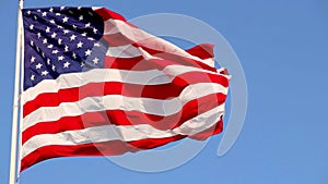 Beautiful American flag waving in the wind, with vibrant red white and blue colors filling the frame completely