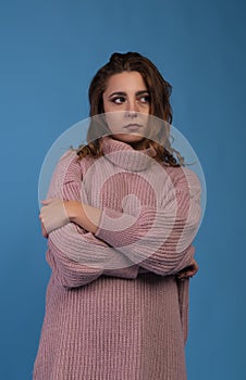 Beautiful American girl teenager female young woman wearing a pink tunic looking sad depressed or thoughtful