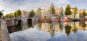 Beautiful Amsterdam sunset. Typical old dutch houses on the bridge and canals in spring, Netherlands