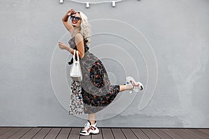 Beautiful amusing young stylish girl with a fashionable white