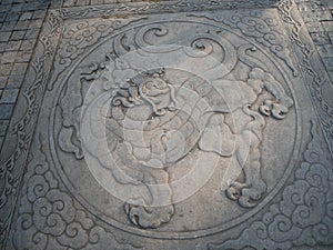 A beautiful ancient Chinese dragon pattern on the street ground in Guandu Ancient town