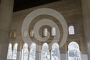 Beautiful ancient islamic architecture style inside of alhambra antique palace with arc windows and relief