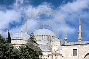 A beautiful ancient mosque against a background of blue sky with clouds