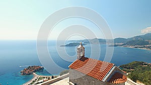 Beautiful ancient Sveti Savva church overlooking the coastline and the Sveti Stefan island