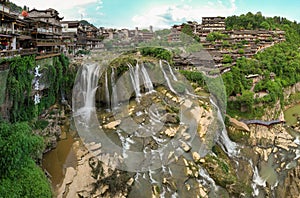 Beautiful ancient town in China with waterfall and traditional houses