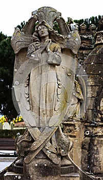 Beautiful angel holding the cross between her wings