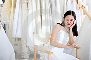 Beautiful angry and agressive shouting bride wearing white dress, screaming and crying at someone