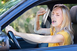 beautiful angry woman honking in car