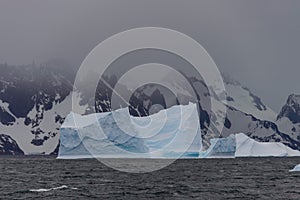 Beautiful antarctic landscape with iceberg and mountains