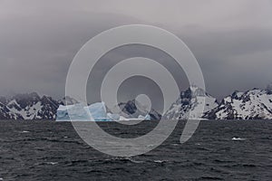 Beautiful antarctic landscape with iceberg and mountains