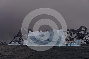 Beautiful antarctic landscape with iceberg and mountains