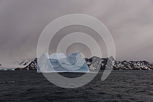 Beautiful antarctic landscape with iceberg and mountains