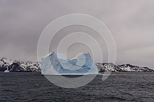 Beautiful antarctic landscape with iceberg and mountains