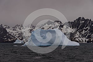 Beautiful antarctic landscape with iceberg and mountains