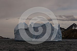 Beautiful antarctic landscape with iceberg and mountains