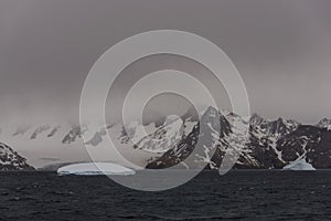 Beautiful antarctic landscape with iceberg and mountains