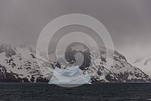 Beautiful antarctic landscape with iceberg and mountains