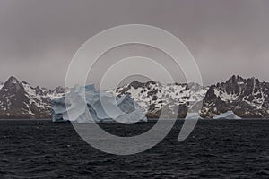 Beautiful antarctic landscape with iceberg and mountains
