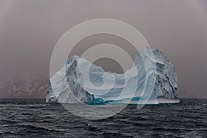 Beautiful antarctic landscape with iceberg and mountains