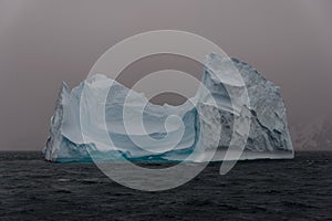 Beautiful antarctic landscape with iceberg and mountains