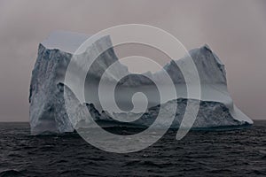 Beautiful antarctic landscape with iceberg and mountains