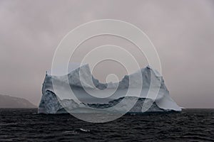 Beautiful antarctic landscape with iceberg and mountains