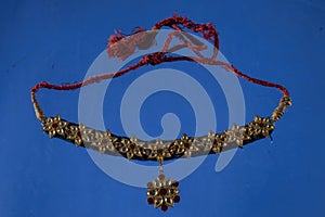 Beautiful antique indian necklace isolated on blue background with diamond and stone