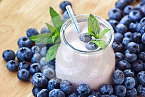 Beautiful appetizer blueberry fruit smoothie milk shake glass jar with juicy fresh berries background top view Yogurt cocktail Nat