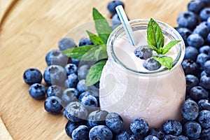 Beautiful appetizer blueberry fruit smoothie milk shake glass jar with juicy fresh berries background top view Yogurt cocktail Nat