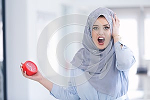 Beautiful Arab businesswoman shock at deadline clock in office