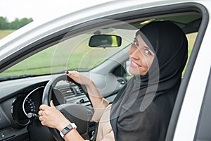 Beautiful arab muslim woman driving car