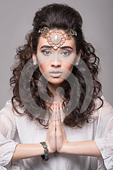 Beautiful arab woman with curly hair wearing jewelery