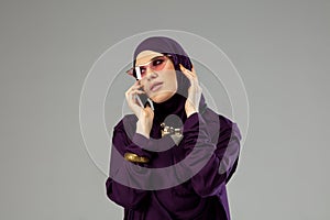 Beautiful arab woman posing in stylish hijab isolated on studio background. Fashion concept