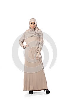 Beautiful arab woman posing in stylish hijab isolated on studio background. Fashion concept