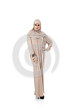 Beautiful arab woman posing in stylish hijab isolated on studio background. Fashion concept